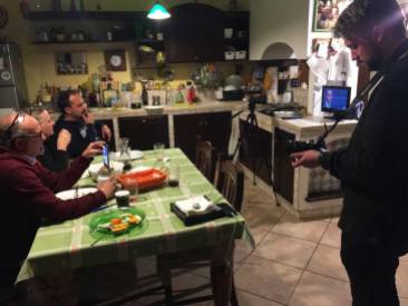 Nick filming Lorenzo and parents in their kitchen.